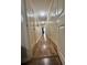 Hallway with wood floors, neutral paint, and multiple closet doors at 1311 N Brandy Se Shls, Conyers, GA 30013