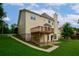 View of the backyard with a deck, patio, and ample green space, ideal for relaxation and entertainment at 1847 Oak Rd, Snellville, GA 30078
