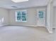 Finished basement area with a walkout door and carpet flooring at 1847 Oak Rd, Snellville, GA 30078