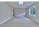 Finished basement area with a window and carpet flooring at 1847 Oak Rd, Snellville, GA 30078
