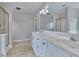 Bright bathroom with double vanity, a large mirror, and a glass-enclosed shower at 1847 Oak Rd, Snellville, GA 30078