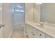 Bathroom featuring a vanity with a sink and mirror, a shower-tub combo, and neutral wall and floor colors at 1847 Oak Rd, Snellville, GA 30078