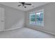 Neutral bedroom with carpet, window, and ceiling fan at 1847 Oak Rd, Snellville, GA 30078