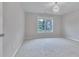 Bright bedroom featuring neutral walls and carpet with a large window bringing in ample natural light at 1847 Oak Rd, Snellville, GA 30078
