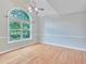 Versatile room with vaulted ceiling, hardwood floors, and large arched window for ample natural light at 1847 Oak Rd, Snellville, GA 30078