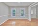 This dining area has hardwood floors, two windows, chair rail, and neutral paint at 1847 Oak Rd, Snellville, GA 30078