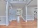 Spacious foyer with hardwood floors, neutral walls, and elegant trim work creates a grand entrance at 1847 Oak Rd, Snellville, GA 30078