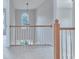Hallway with wood railing with access to additional bedrooms or living spaces at 1847 Oak Rd, Snellville, GA 30078