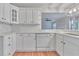 This updated kitchen includes white cabinets, granite countertops, and new backsplash at 1847 Oak Rd, Snellville, GA 30078