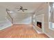 This living room features hardwood floors, fireplace, fan, and stairs at 1847 Oak Rd, Snellville, GA 30078