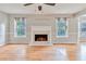 This living room features hardwood floors, fireplace, fan, and natural light at 1847 Oak Rd, Snellville, GA 30078