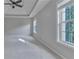 Spacious main bedroom features a tray ceiling and large windows offering views at 1847 Oak Rd, Snellville, GA 30078