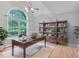 Well-lit home office with a large window, vaulted ceilings, and custom shelving for a productive workspace at 1847 Oak Rd, Snellville, GA 30078