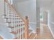 Beautiful foyer staircase with wood stairs and white risers leads to the upper level at 1847 Oak Rd, Snellville, GA 30078