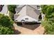 Aerial view of home with manicured lawn and mature trees at 2410 Clock Face Ct, Lawrenceville, GA 30043