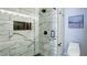 Elegant bathroom showcasing a glass shower with decorative tile and modern toilet and fixtures at 2410 Clock Face Ct, Lawrenceville, GA 30043