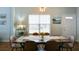 Bright dining room with wooden table and chairs and a large window at 2410 Clock Face Ct, Lawrenceville, GA 30043
