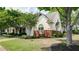 Charming two-story home with a well-manicured lawn, red brick accents, and a welcoming front entrance at 2410 Clock Face Ct, Lawrenceville, GA 30043