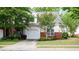 Charming home exterior with a well-manicured lawn and attached garage at 2410 Clock Face Ct, Lawrenceville, GA 30043