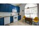 Bright kitchen with blue cabinets, modern appliances, and a breakfast nook bathed in natural light at 2410 Clock Face Ct, Lawrenceville, GA 30043