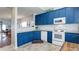 Stylish kitchen with bright blue cabinets and granite countertops at 2410 Clock Face Ct, Lawrenceville, GA 30043
