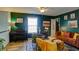 Second floor living room featuring updated lighting and decor with stylish and comfortable seating and a piano at 2410 Clock Face Ct, Lawrenceville, GA 30043