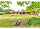 Expansive backyard featuring a large grassy lawn and a brick house with a patio, perfect for outdoor activities at 2668 Kings Park Cir, Decatur, GA 30034