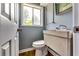 Powder room featuring classic fixtures, wood-look floor, and natural light at 2668 Kings Park Cir, Decatur, GA 30034