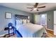 Well-lit bedroom with a tufted headboard, ceiling fan, and closet, offering a comfortable and organized space at 2668 Kings Park Cir, Decatur, GA 30034