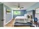 Stylish bedroom with a tufted headboard, ceiling fan, and light hardwood floors, offering a comfortable retreat at 2668 Kings Park Cir, Decatur, GA 30034