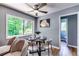 Charming dining area features hardwood floors, modern lighting, and views of the landscaped yard at 2668 Kings Park Cir, Decatur, GA 30034