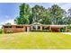 Charming brick home with a well-manicured lawn and mature trees at 2668 Kings Park Cir, Decatur, GA 30034