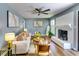 Bright living room featuring hardwood floors and a painted brick fireplace at 2668 Kings Park Cir, Decatur, GA 30034