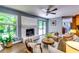 Cozy living room with a white brick fireplace, backyard view, and plenty of natural light at 2668 Kings Park Cir, Decatur, GA 30034