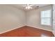 Comfortable bedroom with hardwood floors, ceiling fan, and a bright window at 307 Lee Miller Dr, Suwanee, GA 30024