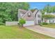 Two-story home with brick accents, attached garage, and a fenced yard at 307 Lee Miller Dr, Suwanee, GA 30024
