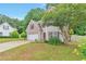 Front exterior view of home with a manicured lawn and mature landscaping at 307 Lee Miller Dr, Suwanee, GA 30024