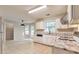 Well-lit kitchen features white cabinets, marble countertops, stainless steel appliances and tiled flooring at 307 Lee Miller Dr, Suwanee, GA 30024