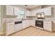 Efficient kitchen with white cabinets, marble countertops, tile flooring, and modern appliances, perfect for cooking at 307 Lee Miller Dr, Suwanee, GA 30024