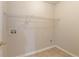 Functional laundry room with tile floor, wire shelving, and utility hookups at 307 Lee Miller Dr, Suwanee, GA 30024