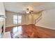 Inviting living room features hardwood floors, a fireplace, a large window and stairs to the second floor at 307 Lee Miller Dr, Suwanee, GA 30024