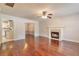 Spacious living room with hardwood floors, fireplace, and view into the dining room and kitchen at 307 Lee Miller Dr, Suwanee, GA 30024