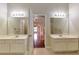 Dual vanity sinks, and doorway leading to main bedroom in main bathroom at 307 Lee Miller Dr, Suwanee, GA 30024