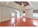 Spacious main bedroom with trey ceiling, fan and windows, and gleaming wood floors at 307 Lee Miller Dr, Suwanee, GA 30024
