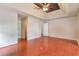 Spacious main bedroom with trey ceiling, fan and wood floors leading to en suite bathroom at 307 Lee Miller Dr, Suwanee, GA 30024