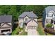An aerial view of the brick home showing its roof, landscaping, and proximity to neighboring houses at 456 Crestmont Ln, Canton, GA 30114