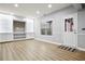 Finished basement features custom built-ins, vinyl floors, and a walkout for entertainment and recreation at 456 Crestmont Ln, Canton, GA 30114