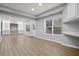 Finished basement with built-in shelving, windows, and vinyl floors offering a versatile living space at 456 Crestmont Ln, Canton, GA 30114