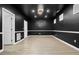 A finished basement featuring dark-colored walls and light hardwood flooring at 456 Crestmont Ln, Canton, GA 30114
