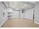 Spacious finished basement with stylish flooring, office nook, and bright lighting creating a flexible living area at 456 Crestmont Ln, Canton, GA 30114